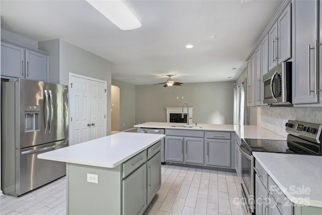 9321 Bradstreet Commons Way, Charlotte, NC 28215 - kitchen featuring appliances with stainless steel finishes, gray cabinetry, a peninsula, ceiling fan, and recessed lighting