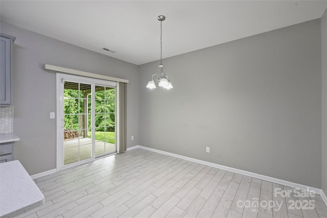 9321 Bradstreet Commons Way, Charlotte, NC 28215 - unfurnished dining area with baseboards, a chandelier, and light wood-style flooring