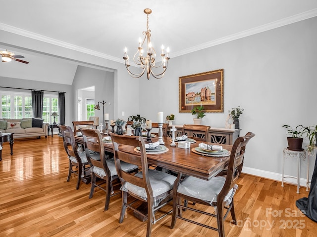 dining room with crown molding, baseboards, ceiling fan with notable chandelier, and light wood-type flooring
