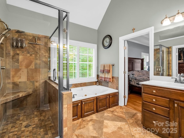 full bathroom with a whirlpool tub, ensuite bath, a stall shower, and vaulted ceiling