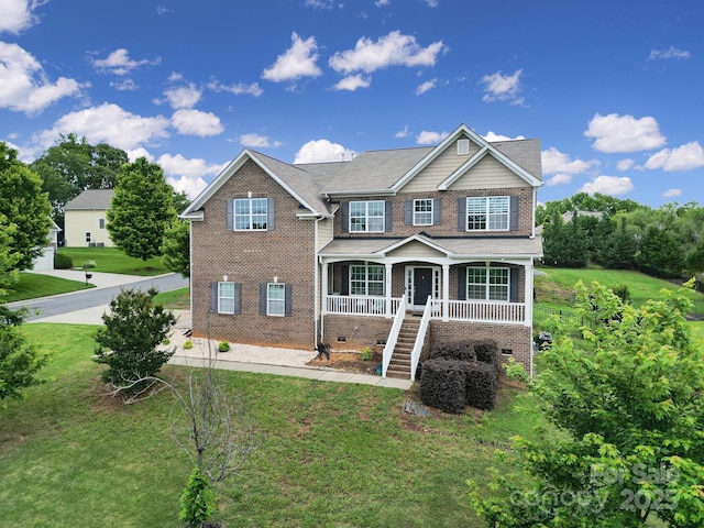 9029 Woodview Ct, Fort Mill, SC 29707 - traditional-style home with covered porch, stairway, a front yard, and brick siding