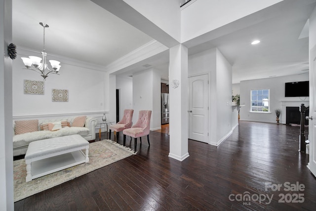 9029 Woodview Ct, Fort Mill, SC 29707 - living area with hardwood / wood-style flooring, baseboards, a fireplace, crown molding, and a chandelier