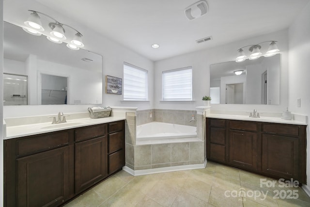 9029 Woodview Ct, Fort Mill, SC 29707 - bathroom with two vanities, a garden tub, tile patterned floors, and a shower