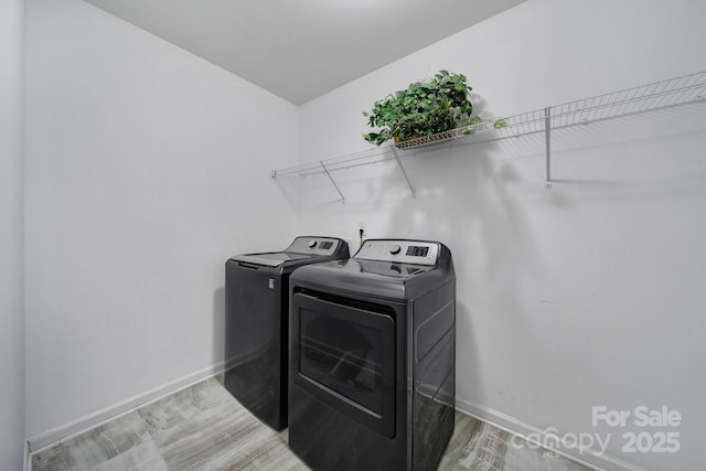 9029 Woodview Ct, Fort Mill, SC 29707 - washroom with washer and clothes dryer, baseboards, and light wood-style flooring