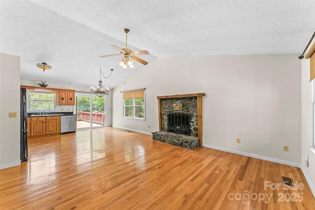 6562 Gingercake Rd, Newland, NC 28657 - unfurnished living room with light wood-style flooring, a chandelier, ceiling fan, a fireplace, and vaulted ceiling