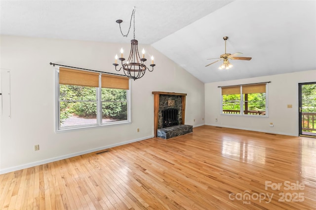 6562 Gingercake Rd, Newland, NC 28657 - unfurnished living room with light wood finished floors, ceiling fan, a chandelier, a stone fireplace, and baseboards