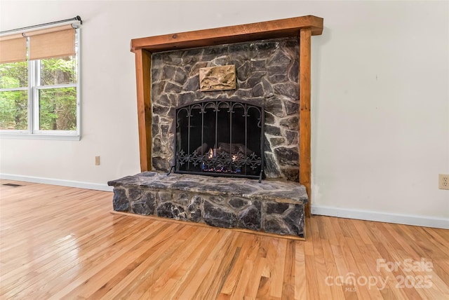 6562 Gingercake Rd, Newland, NC 28657 - detailed view of baseboards, wood finished floors, and a fireplace