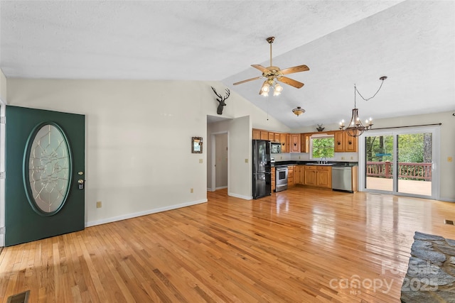 6562 Gingercake Rd, Newland, NC 28657 - kitchen with appliances with stainless steel finishes, a ceiling fan, light wood-style floors, dark countertops, and lofted ceiling