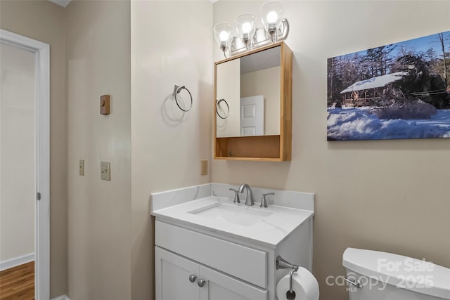 6562 Gingercake Rd, Newland, NC 28657 - bathroom featuring vanity, toilet, and a chandelier