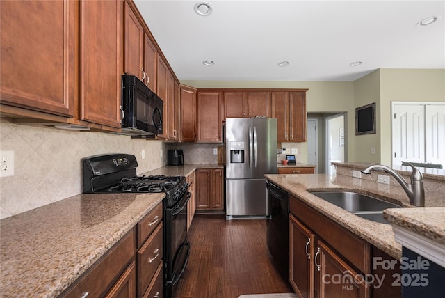 9159 Marasol Ln, Concord, NC 28027 - kitchen with black appliances, a sink, dark wood finished floors, light stone countertops, and backsplash