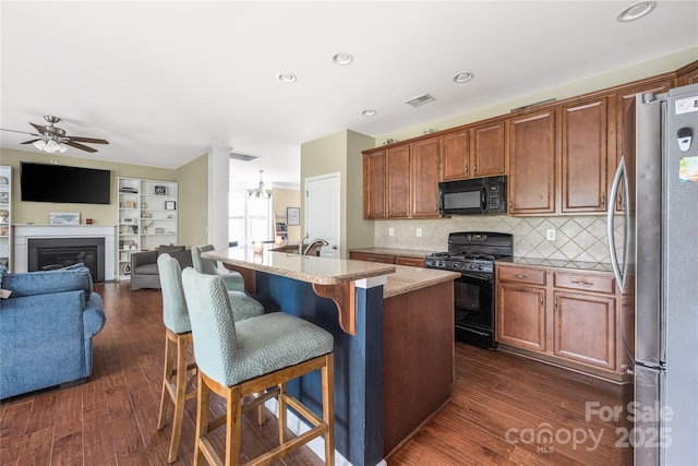 9159 Marasol Ln, Concord, NC 28027 - kitchen with black appliances, ceiling fan, open floor plan, dark wood finished floors, and tasteful backsplash