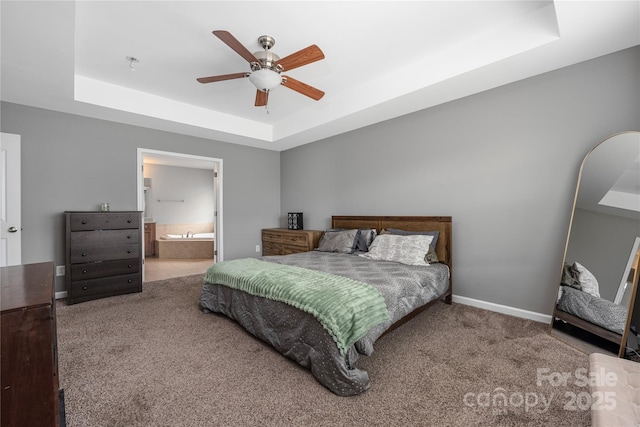 9159 Marasol Ln, Concord, NC 28027 - carpeted bedroom with a raised ceiling, a ceiling fan, baseboards, and connected bathroom