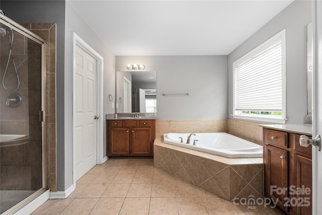 9159 Marasol Ln, Concord, NC 28027 - bathroom featuring tile patterned floors, a stall shower, a bath, and vanity