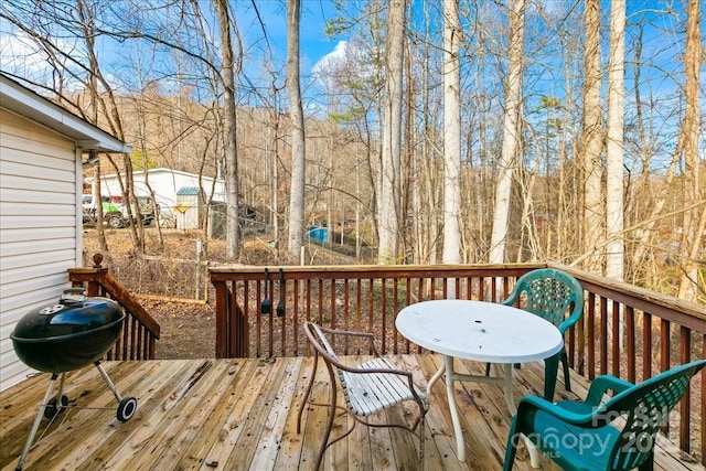 wooden deck with a grill