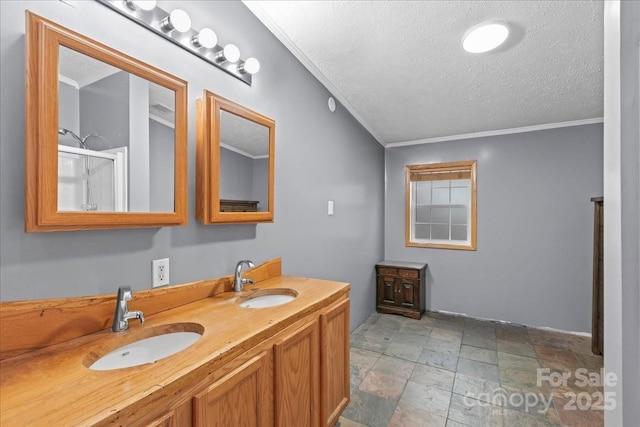 bathroom with double vanity, a textured ceiling, stone finish floor, and a sink