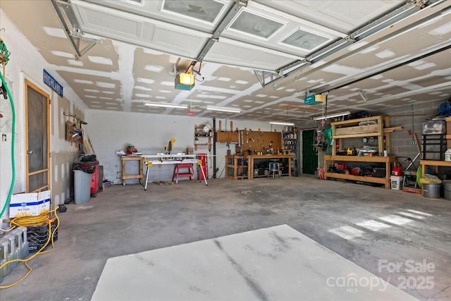 garage with a workshop area and a garage door opener