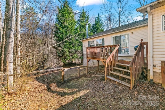 view of yard with a deck and fence