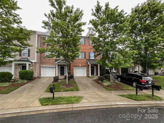 view of property with brick siding, driveway, and an attached garage