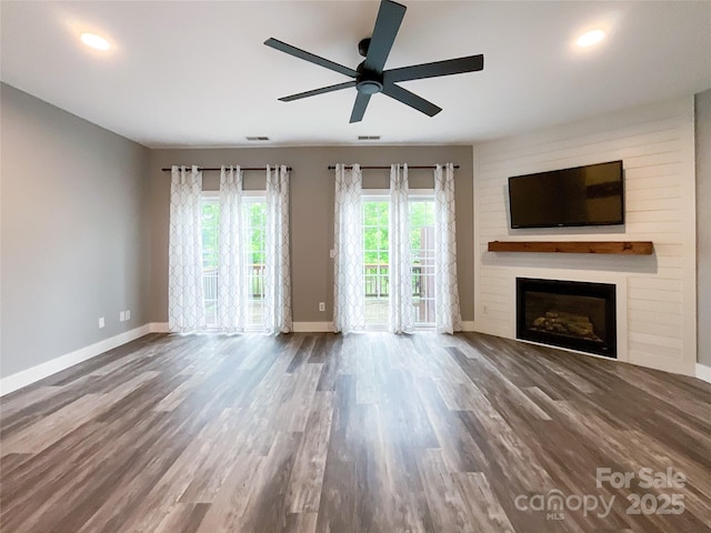 unfurnished living room featuring baseboards, a fireplace, a ceiling fan, wood finished floors, and recessed lighting