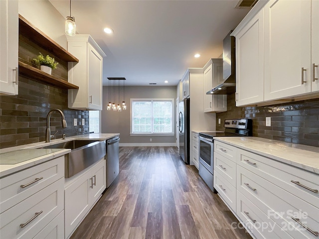 kitchen featuring stainless steel appliances, wall chimney exhaust hood, open shelves, baseboards, and dark wood finished floors