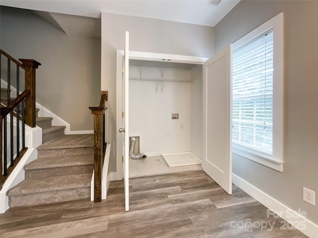 clothes washing area featuring hookup for a washing machine, wood finished floors, and baseboards