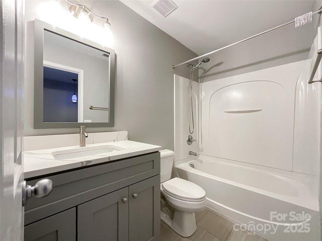 bathroom with toilet, vanity, and shower / bathtub combination