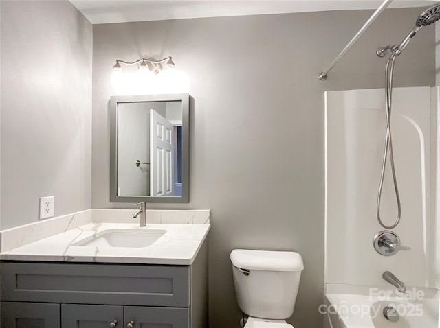 bathroom featuring vanity, toilet, and washtub / shower combination