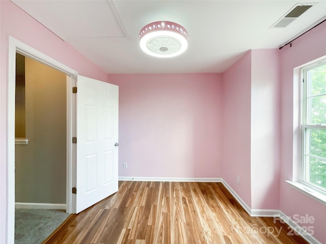 unfurnished room featuring wood finished floors and baseboards