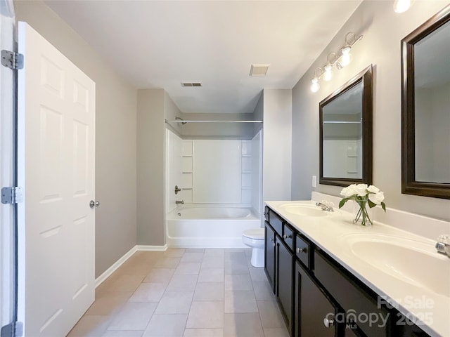 bathroom with toilet, double vanity, shower / bath combination, baseboards, and tile patterned floors