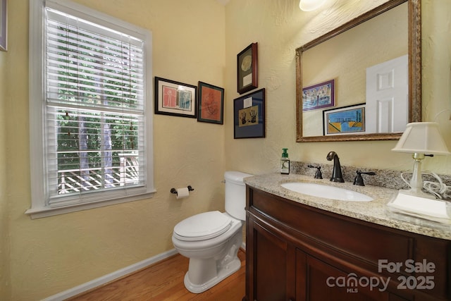 160 Fernbrook Dr, Mooresville, NC 28117 - half bathroom featuring vanity, wood finished floors, and a textured wall