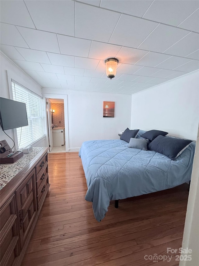 bedroom featuring light wood-style floors and ensuite bathroom