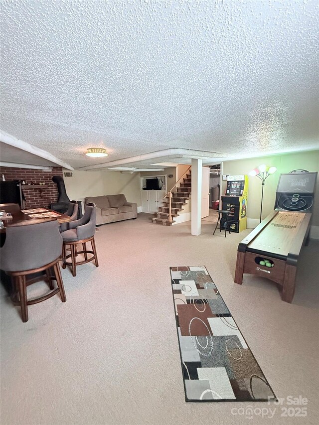game room with a textured ceiling and carpet