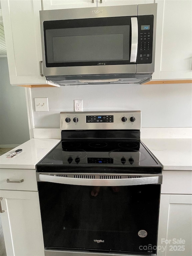 kitchen featuring white cabinetry, light countertops, and appliances with stainless steel finishes
