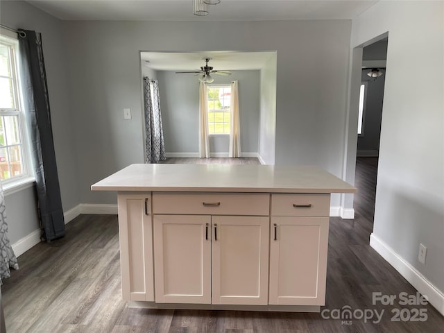 kitchen featuring dark wood-style floors, light countertops, and baseboards