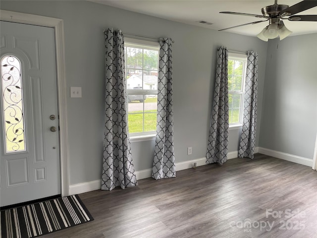 foyer entrance featuring ceiling fan, a wealth of natural light, visible vents, and wood finished floors