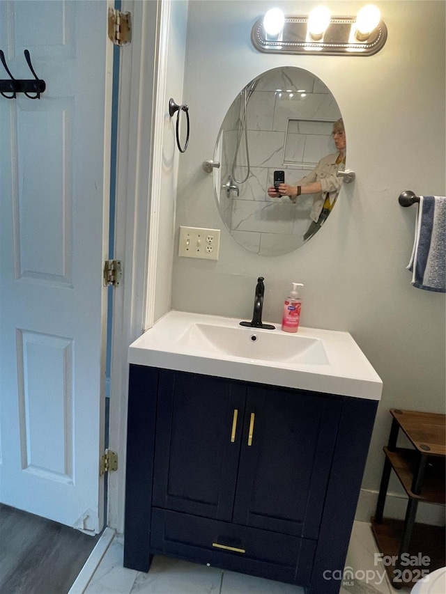 bathroom featuring marble finish floor and vanity