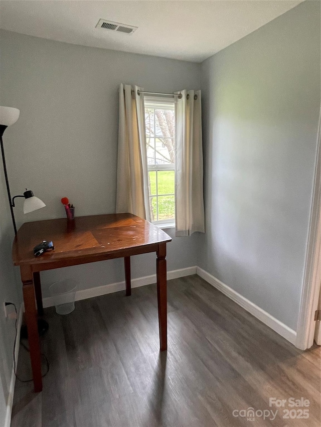 office featuring baseboards, visible vents, and wood finished floors