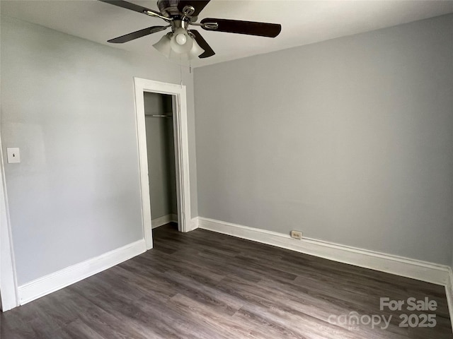 unfurnished bedroom with baseboards, a closet, ceiling fan, and dark wood-type flooring