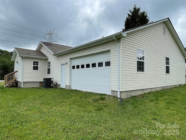 view of side of property featuring central AC unit, entry steps, an attached garage, and a lawn