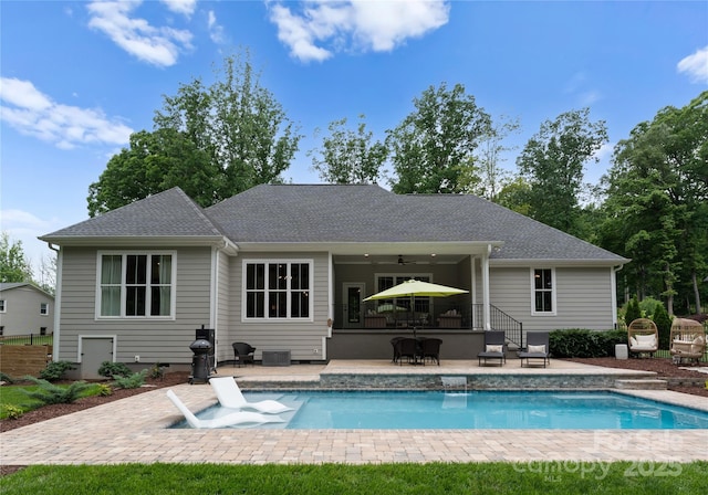 2646 Lee Lawing Rd, Lincolnton, NC 28092 - rear view of house with a patio area, a ceiling fan, an outdoor pool, and a shingled roof