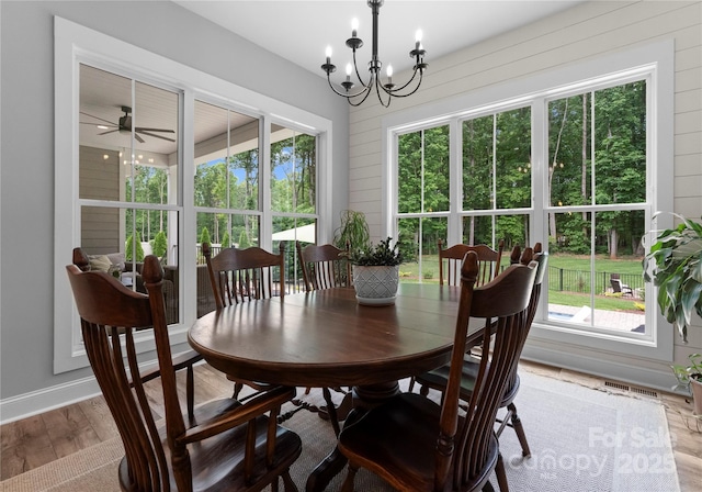 2646 Lee Lawing Rd, Lincolnton, NC 28092 - dining area featuring wood finished floors, a chandelier, a ceiling fan, and baseboards
