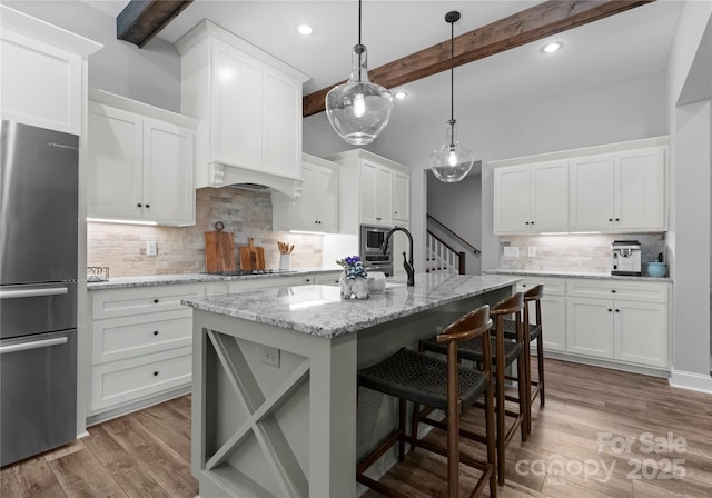 2646 Lee Lawing Rd, Lincolnton, NC 28092 - kitchen featuring freestanding refrigerator, beamed ceiling, tasteful backsplash, black electric cooktop, and wood finished floors