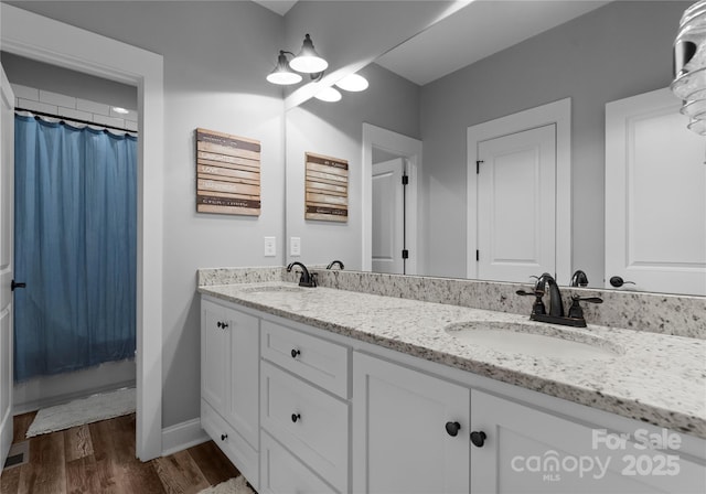 2646 Lee Lawing Rd, Lincolnton, NC 28092 - full bath with double vanity, wood finished floors, baseboards, and a shower with shower curtain