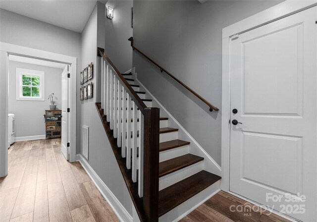 2646 Lee Lawing Rd, Lincolnton, NC 28092 - stairs with wood finished floors, washer / clothes dryer, and baseboards
