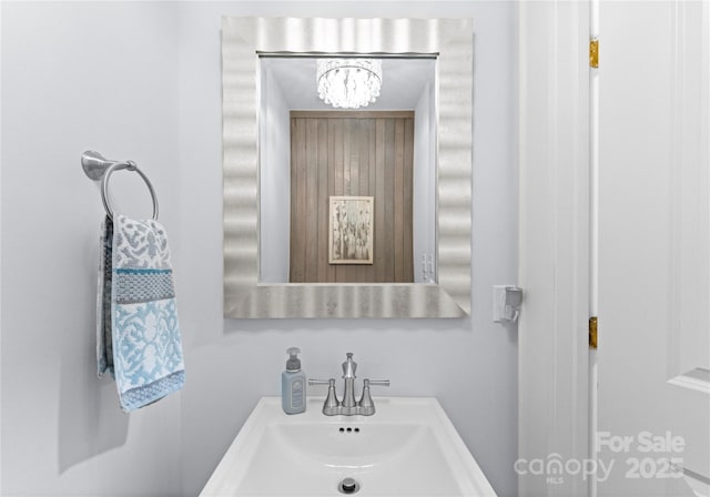 bathroom with a chandelier and a sink