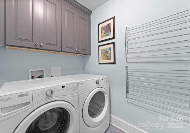 laundry room featuring cabinet space, separate washer and dryer, and baseboards