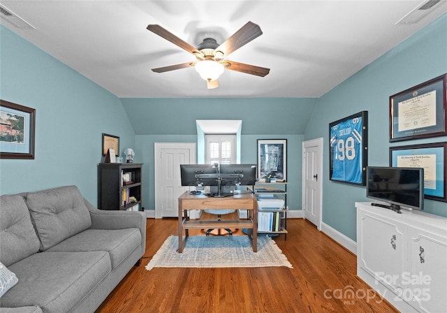 office with lofted ceiling, a ceiling fan, wood finished floors, and baseboards