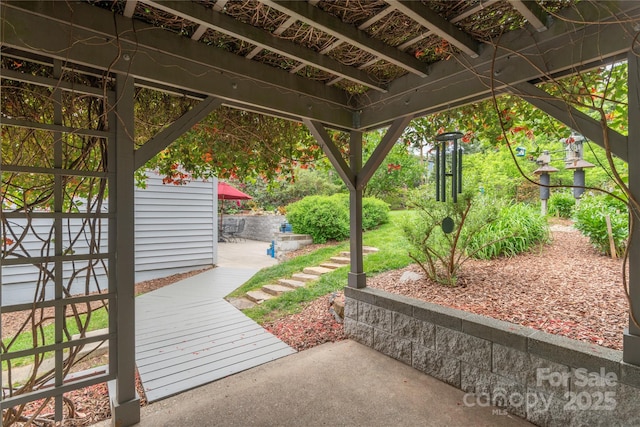 view of patio with a wooden deck and a pergola