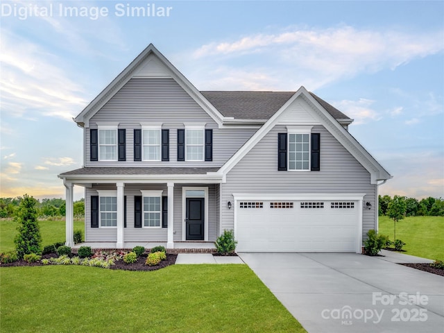 traditional-style house featuring a front lawn, covered porch, roof with shingles, an attached garage, and driveway