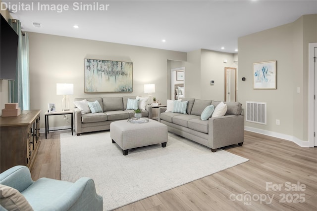 living area featuring recessed lighting, baseboards, visible vents, and light wood-style flooring
